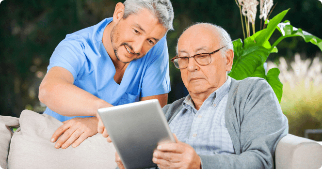 Nurse teaching a senior how to use a tablet